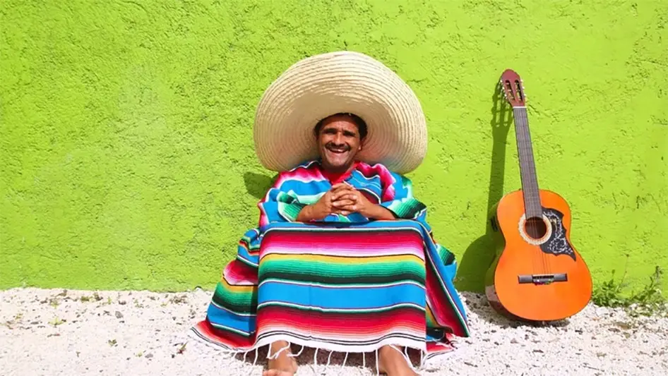 smiling mexican with guitar on the street